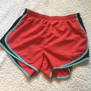 Coral Nike running shorts